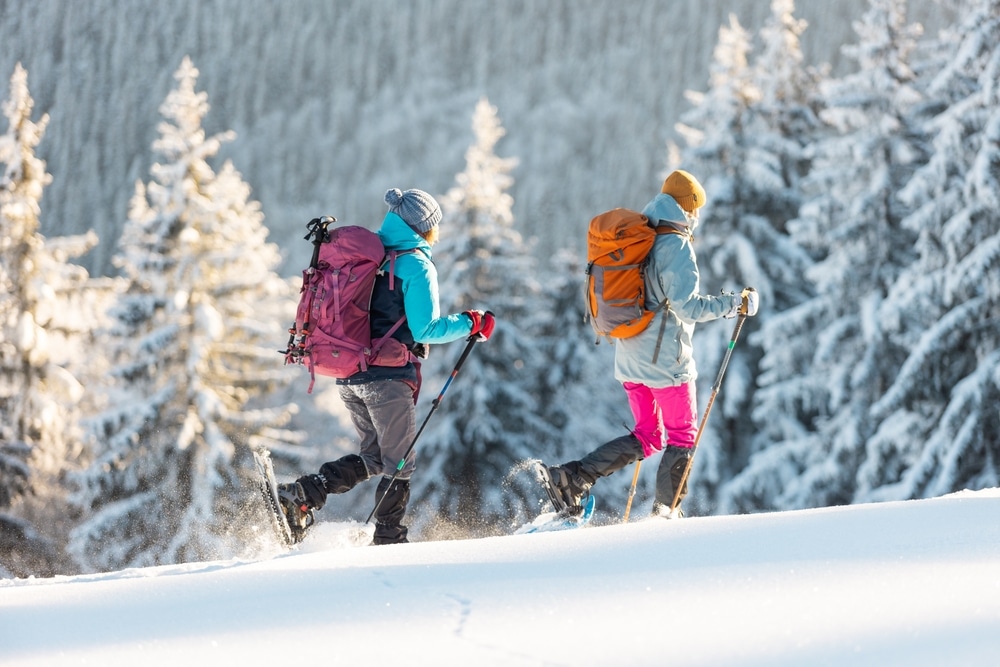 Snowmobiling in Montana is the only thing to do in Missoula this winter - here's a couple snowshoeing through the winter wonderland