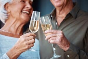 Senior couple sharing a toast of champagne while enjoying a romantic date night at Plonk Missoula near our romantic Missoula Bed and Breakfast