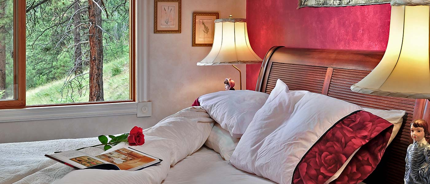 A cozy bed turned down and waiting for you to book your stay at the Blue Mountain Bed and Breakfast. We'll leave the lamp on!