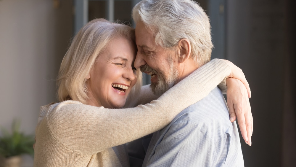 A relaxed older couple laughs together while they unwind at the Blue Mountain Bed and Breakfast.