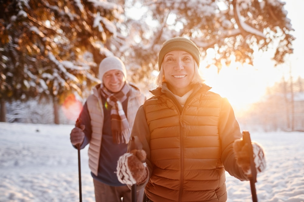 An older couple enjoys cross country skiing together in the mountains, one of the most popular things to do in Montana for couples this winter.