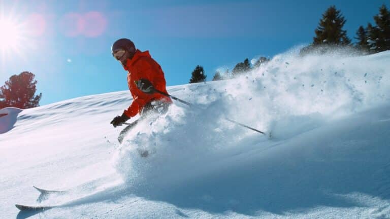 Enjoy Missoula skiing and all of the other winter things to do when you stay at our Bed and Breakfast in Missoula. Man in red jacket skiing.